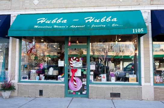 A store front with a green awningDescription automatically generated
